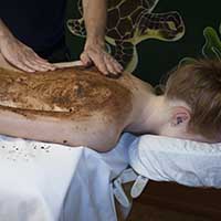 Woman receiving chocolate body scrub at Goodyear, AZ day spa