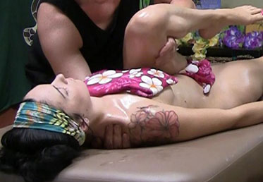 Young woman being stretched during lomi massage in Scottsdale day spa